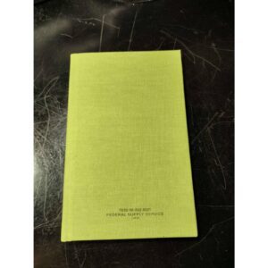 Closed green book on a dark surface.